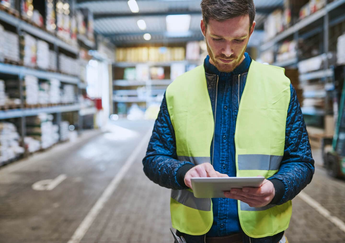 Man working on an ipad in a warehouse